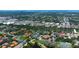 Aerial view of community featuring tennis courts, pool, and nearby shopping, surrounded by lush greenery at 2400 Winding Creek Blvd # Bldg18A210, Clearwater, FL 33761