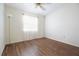 Bedroom with a light wood floor and a sheer curtain at 2400 Winding Creek Blvd # Bldg18A210, Clearwater, FL 33761