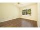 Bright bedroom with wood floors, large window, and a ceiling fan at 2400 Winding Creek Blvd # Bldg18A210, Clearwater, FL 33761