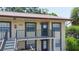 Exterior of a lovely condo building, highlighting the private balcony and well-lit entrance at 2400 Winding Creek Blvd # Bldg18A210, Clearwater, FL 33761