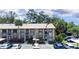 Exterior of a charming condo building with well-maintained landscaping, balconies, and convenient parking spaces at 2400 Winding Creek Blvd # Bldg18A210, Clearwater, FL 33761