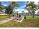 Outdoor grilling area with picnic tables, grills, and a serene green space for community gatherings at 2400 Winding Creek Blvd # Bldg18A210, Clearwater, FL 33761