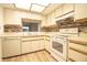 Kitchen with light-colored cabinets and backsplash at 2400 Winding Creek Blvd # Bldg18A210, Clearwater, FL 33761