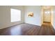 Bright living room featuring wood flooring, lots of natural light, and a view into the kitchen at 2400 Winding Creek Blvd # Bldg18A210, Clearwater, FL 33761