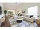 Staged living room featuring modern furniture, elegant decor, and abundant natural light at 2400 Winding Creek Blvd # Bldg18A210, Clearwater, FL 33761