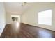 Open and airy living room with wood floors, large windows, and a ceiling fan for added comfort at 2400 Winding Creek Blvd # Bldg18A210, Clearwater, FL 33761