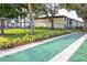 Relaxing shuffleboard court surrounded by lush landscaping and shaded trees at 2400 Winding Creek Blvd # Bldg18A210, Clearwater, FL 33761