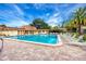 Community swimming pool with lounge chairs, tables, and lush landscaping for a relaxing atmosphere at 2400 Winding Creek Blvd # Bldg18A210, Clearwater, FL 33761