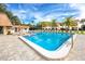 Community swimming pool with lounge chairs, tables, and lush landscaping for a relaxing atmosphere at 2400 Winding Creek Blvd # Bldg18A210, Clearwater, FL 33761