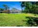 Sprawling backyard featuring a sparkling pool and expansive lawn, perfect for recreation and relaxation at 2532 Sweetgum W Way, Clearwater, FL 33761