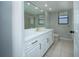 This bathroom boasts a spacious vanity, ample storage, and neutral finishes for a clean, timeless appeal at 2532 Sweetgum W Way, Clearwater, FL 33761