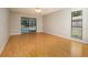 Bedroom with wood floors, natural light, pool view, and sliding door access at 2532 Sweetgum W Way, Clearwater, FL 33761