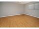 This bedroom is a blank canvas with a light color scheme and warm wood-look flooring at 2532 Sweetgum W Way, Clearwater, FL 33761