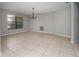 Inviting dining room with neutral paint, tile floors, large windows and decorative chandelier at 2532 Sweetgum W Way, Clearwater, FL 33761
