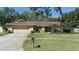 A charming single-story home featuring a two-car garage and stone accents at 2532 Sweetgum W Way, Clearwater, FL 33761