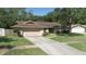 Charming single-story home with a well-maintained lawn and attached two-car garage at 2532 Sweetgum W Way, Clearwater, FL 33761