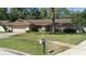 A well-maintained single-story home with a front lawn and charming stone details at 2532 Sweetgum W Way, Clearwater, FL 33761