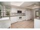 Bright kitchen with granite countertops, white appliances, white cabinets, and tile floors at 2532 Sweetgum W Way, Clearwater, FL 33761