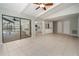 Open concept floor plan featuring tile floors, a ceiling fan and access to kitchen and lanai at 2532 Sweetgum W Way, Clearwater, FL 33761