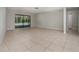 Bright living room featuring tile floors and sliding glass doors to a screened in pool area at 2532 Sweetgum W Way, Clearwater, FL 33761