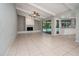 Open concept floor plan featuring a white fireplace, tile floors, and view of screened-in pool at 2532 Sweetgum W Way, Clearwater, FL 33761