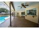 Relax on this covered patio, complete with a ceiling fan and pass-through window for seamless indoor-outdoor entertaining at 2532 Sweetgum W Way, Clearwater, FL 33761