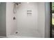 Updated shower featuring white subway tile, niche, and modern fixtures at 2532 Sweetgum W Way, Clearwater, FL 33761
