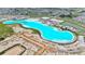 Expansive aerial view of the community's lagoon, showcasing its size, beaches, and access to residential areas at 31105 Mango Fade Way, San Antonio, FL 33576