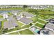 Beautiful aerial view of a Primary planned community surrounding a lake with ample green space and a pool at 31105 Mango Fade Way, San Antonio, FL 33576