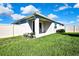 Backyard features a covered patio, fully fenced with landscaping at 31105 Mango Fade Way, San Antonio, FL 33576