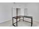 This bedroom features light gray walls and carpet along with a modern, black desk at 31105 Mango Fade Way, San Antonio, FL 33576