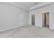 Carpeted bedroom featuring a walk-in closet and bathroom at 31105 Mango Fade Way, San Antonio, FL 33576