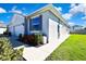 Charming home with a two-car garage, manicured landscaping, and a welcoming walkway at 31105 Mango Fade Way, San Antonio, FL 33576