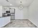 Gray kitchen cabinets complement the granite countertops and geometric lighting at 31105 Mango Fade Way, San Antonio, FL 33576