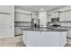 A kitchen with an island, stainless appliances, and gray subway tile backsplash at 31105 Mango Fade Way, San Antonio, FL 33576