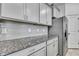 Gray subway tile backsplash accents the granite countertops and stainless steel appliances at 31105 Mango Fade Way, San Antonio, FL 33576