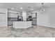 A spacious kitchen with gray cabinets, granite countertops, and stainless steel appliances at 31105 Mango Fade Way, San Antonio, FL 33576
