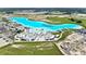 Aerial view of a neighborhood amenity lagoon and beach club. Plenty of space for community recreation at 31105 Mango Fade Way, San Antonio, FL 33576