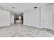 Bright, open-concept living room that flows into the kitchen, featuring neutral tile floors at 31105 Mango Fade Way, San Antonio, FL 33576
