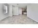Bright, open-concept living room that flows into the kitchen, featuring neutral tile floors at 31105 Mango Fade Way, San Antonio, FL 33576