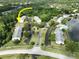 An aerial view shows condominiums, tennis courts, a pool, and reserved parking spaces at 3232 Lake Pine E Way # A2, Tarpon Springs, FL 34688