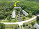An aerial view of condominiums with plenty of parking surrounded by a lush forest at 3232 Lake Pine E Way # A2, Tarpon Springs, FL 34688
