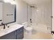 Bathroom featuring a shower-tub combination with white marble tiling and dark fixtures at 3232 Lake Pine E Way # A2, Tarpon Springs, FL 34688