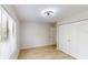 Bright bedroom features wood floors, a window and a closet with bi-fold doors at 3232 Lake Pine E Way # A2, Tarpon Springs, FL 34688