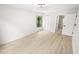 Bright bedroom features light wood floors, a modern ceiling fan, and an ensuite bathroom at 3232 Lake Pine E Way # A2, Tarpon Springs, FL 34688