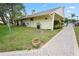 Community exterior with lush landscaping, a sidewalk and mature shade trees at 3232 Lake Pine E Way # A2, Tarpon Springs, FL 34688