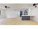Open-concept living room and kitchen with modern lighting fixtures and ceiling fans at 3232 Lake Pine E Way # A2, Tarpon Springs, FL 34688