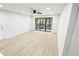 Bright living room with ceiling fan and access to the outdoor space at 3232 Lake Pine E Way # A2, Tarpon Springs, FL 34688