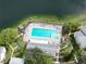 Aerial view of a pool, hot tub and sundeck area near a body of water at 3232 Lake Pine E Way # A2, Tarpon Springs, FL 34688