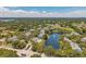 An aerial shot shows a community with a pool, pond, and well-maintained landscaping at 3301 Haviland Ct # 301, Palm Harbor, FL 34684